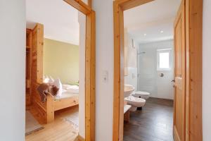 a bathroom with a bed and a toilet in a room at Ferienwohnungen Zwick Maroles in Malles Venosta +16 photos