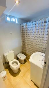 a bathroom with a toilet and a sink at Cornejo Temporarios in Salta