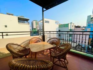 a patio with a table and chairs on a balcony at Ahu Hotel & Apartment in Ho Chi Minh City