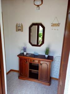 a bathroom with a wooden vanity and a mirror at Apartment Studio Zvonka in Zambratija