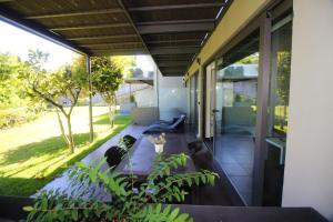 an outdoor patio with a couch and a table at Apartamento Garrano - Casas Barca do Rio by Gerês Casas in Geres