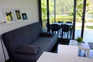 a living room with a couch and a table at Apartamento Garrano - Casas Barca do Rio by Gerês Casas in Geres