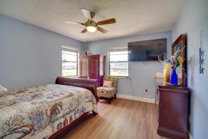 a bedroom with a bed and a ceiling fan at Lakewood Park Retreat on Fairway - 4 Mi to Beach! in Lakewood Park +25 photos