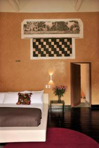 a bedroom with a bed and a checkered wall at Casa Cartagena Boutique Hotel & Spa in Cusco