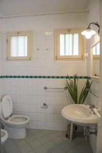 a bathroom with a toilet and a sink at Villino La Casetta in Castelnuovo Magra