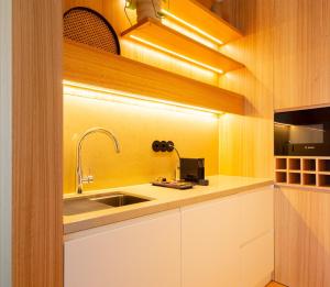 a kitchen with white cabinets and a sink at d'ALMA Boutique Hotel in Porto