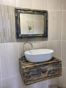 a bathroom with a sink and a mirror at Seqonoka Villa Accommodation & Events Park in Berea Hills