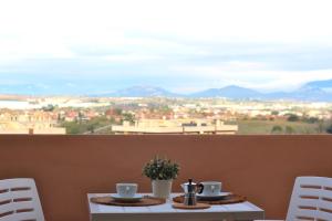 una mesa con 2 tazas de café en la parte superior de un balcón en White House BnB, en Roma