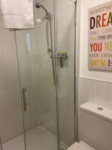 a shower with a glass door in a bathroom at Beau retreat lovely apartment in Beaumaris in Beaumaris