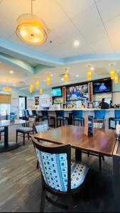 a restaurant with a table and chairs and a bar at Luxury Champions Gate Condo-Disney Firework Views! in Kissimmee