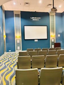 a lecture room with chairs and a screen at Luxury Champions Gate Condo-Disney Firework Views! in Kissimmee