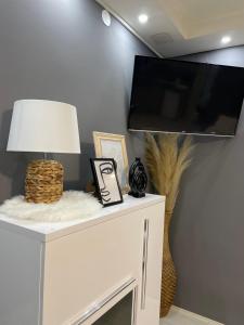 A television and/or entertainment centre at Beta House Apartments