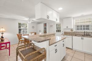 a kitchen with white cabinets and a counter top at Island House Beach Resort 37 in Siesta Key