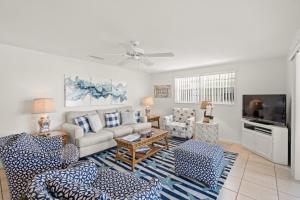 a living room with a couch and a tv at Island House Beach Resort 37 in Siesta Key