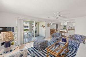 a living room with a couch and chairs and a table at Island House Beach Resort 37 in Siesta Key