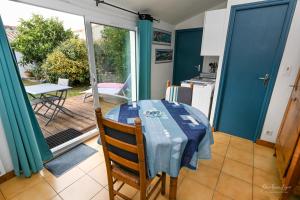 a kitchen with a table with a blue table cloth on it at GÎTE DES FRUCHES in Saint-Gilles-Croix-de-Vie