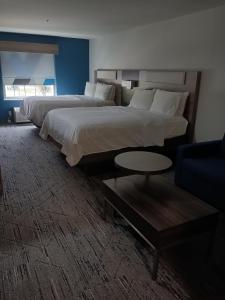 a hotel room with two beds and a couch at Holiday Inn Express & Suites - Jourdanton-Pleasanton, an IHG Hotel in Jourdanton