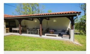 a patio with a gazebo in a yard at Domaine Manon in Buzon