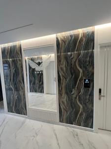 a mirror in a room with a marble wall at Ilio Boutique Hotel in Ksamil