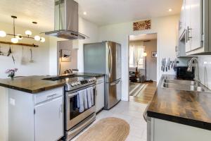 een keuken met een roestvrijstalen koelkast en een wastafel bij Asheville Home with Views Near Blue Ridge Parkway! in Asheville