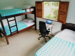 a bedroom with bunk beds and a desk and a chair at Jardín de la Inmaculada - Cabaña in Jardin