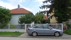 a silver car parked in front of a fence at Nikiva I in Ćuprija