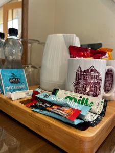 a wooden tray with toothbrushes and a mug on a table at Queenswood Hotel in Weston-super-Mare