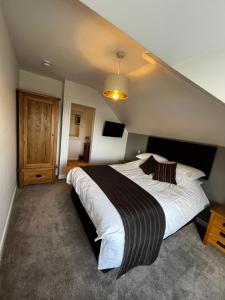 a bedroom with a large bed in a room at Queenswood Hotel in Weston-super-Mare