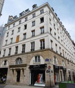 duży biały budynek na rogu ulicy w obiekcie Fabulous of Paris for 4 people w Paryżu