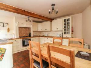 a large kitchen with a wooden table and chairs at Beautiful 3-Bed House in Longnor near Buxton in Longnor