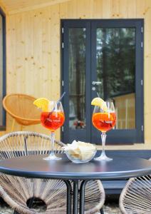 a table with three wine glasses on top of it at Camping la Pineta in Santa Maria Maggiore