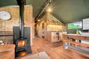 a living room with a fireplace and a stove at Nature's Nest in Hereford