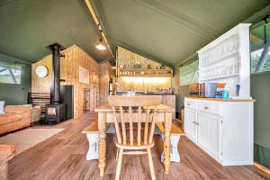 a kitchen and dining room with a table in a tiny house at Nature's Nest in Hereford