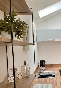 a kitchen with a sink and a counter top at The Broomsquire in Tadley