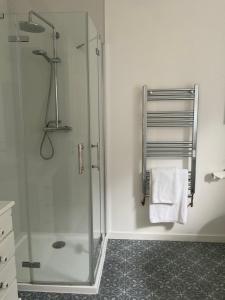 a bathroom with a shower with a glass door at The Broomsquire in Tadley +13 photos