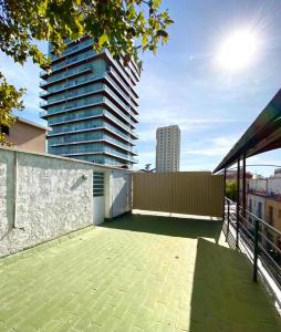 a balcony of a building with a tall building at Duplex con terraza y estacionamiento p auto! in Mendoza