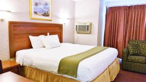 Ένα ή περισσότερα κρεβάτια σε δωμάτιο στο Alpine Motel