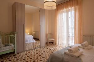 a bedroom with a bed and a large mirror at [3 camere da letto] residenziale - 500 mt dal mare in Civitanova Marche