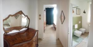 a hallway of a bathroom with a mirror and a sink at Domus Petrae in Ripatransone