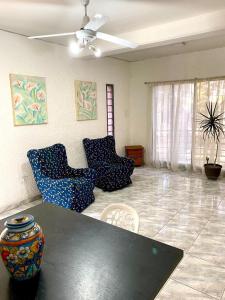 a living room with a black table and chairs at Duplex con terraza y estacionamiento p auto! in Mendoza