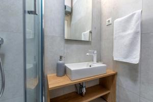 a bathroom with a sink and a shower at Split Luxury Suite in Split +26 photos