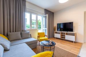 a living room with a couch and a tv at Split Luxury Suite in Split