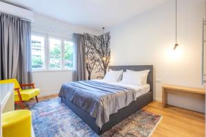 a bedroom with a bed and a yellow chair at Split Luxury Suite in Split