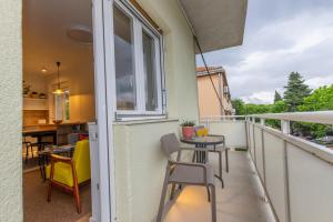 a balcony with a table and chairs and a window at Split Luxury Suite in Split
