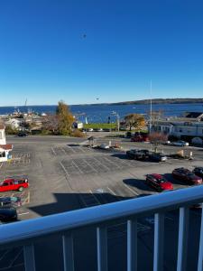 a parking lot with cars parked in a parking lot at Trade Winds on the Bay in Rockland