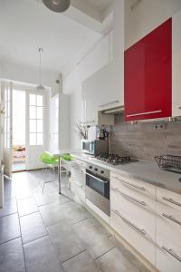 a kitchen with white appliances and a red cabinet at Fresh and Personal near Buda Castle in Budapest