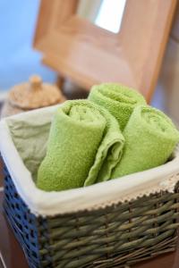a basket filled with green towels on a chair at Fresh and Personal near Buda Castle in Budapest