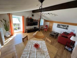 ein Wohnzimmer mit einem Tisch und einem roten Sofa in der Unterkunft Ferienwohnung Gruberhof in Rimsting