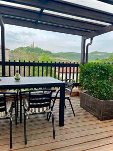 a patio with a table and chairs on a deck at Tarnovgrad Apartments - Free parking in Veliko Tŭrnovo