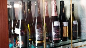 a group of bottles of wine on a shelf at Hotel Nuovo Sole HNS in Bovolone